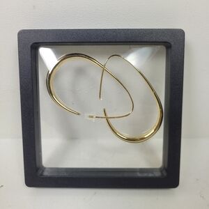 Gold-tone teardrop shaped hoop earring.